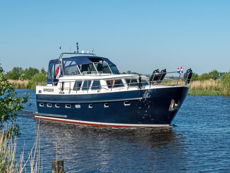 Side view of a motorboat against a blue sky